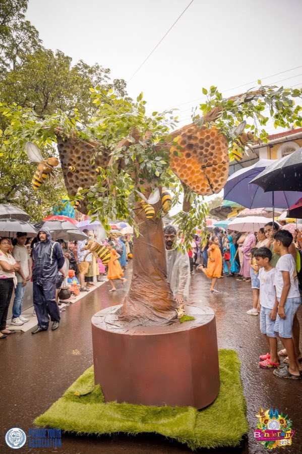 A ward float shaped like a giant honeycomb tree with bees